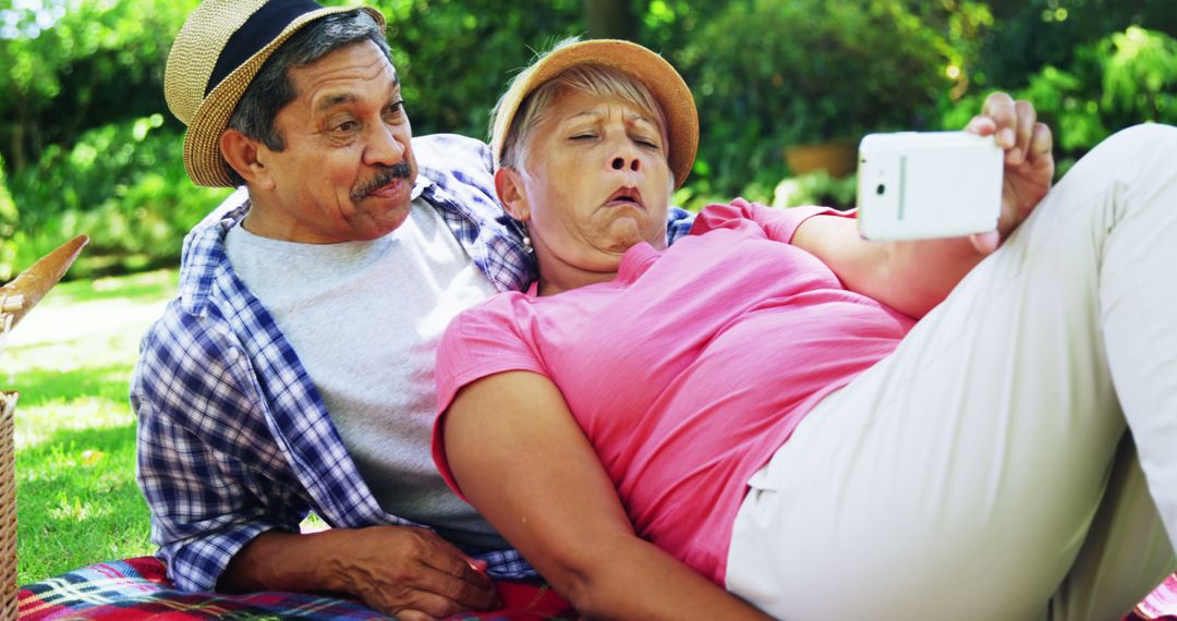 Senior Couple Making Faces While Taking Selfie at Park Picnic - Free Images, Stock Photos and Pictures on Pikwizard.com