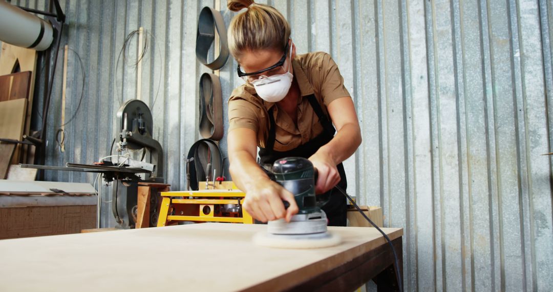 Female woodworking craftsman sanding wooden surface in workshop - Free Images, Stock Photos and Pictures on Pikwizard.com