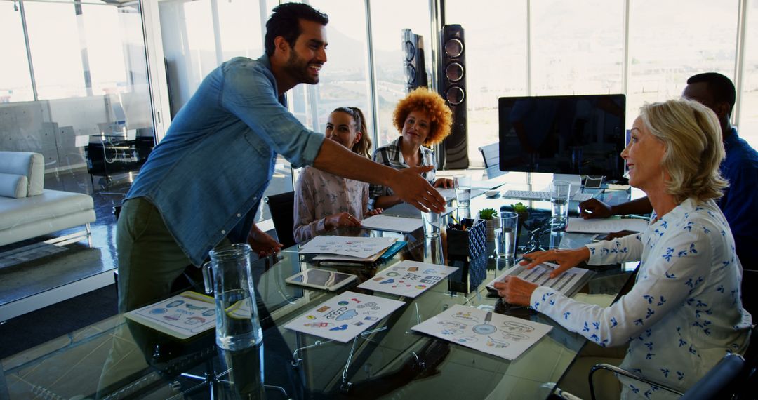 Confident Businessman Shaking Hands in Modern Office Meeting - Free Images, Stock Photos and Pictures on Pikwizard.com