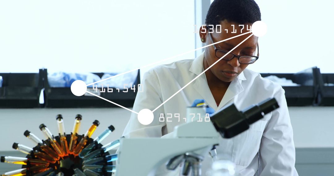 Focused Female Scientist Analyzing Data in Laboratory