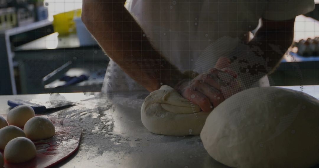 Baker Skillfully Kneading Dough in Rustic Bakery
