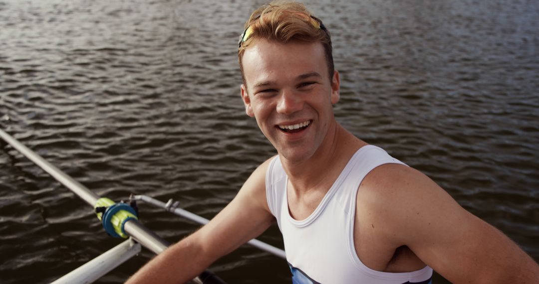 Young Rowing Athlete Smiling During Training on Lake - Free Images, Stock Photos and Pictures on Pikwizard.com