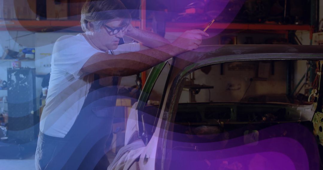 Mechanic Working on Car Shell in Industrial Workshop