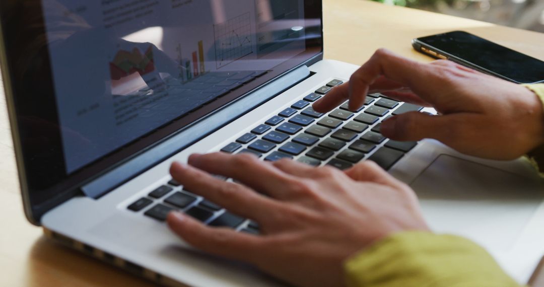 Close-Up of Hands Typing on Laptop with Business Analytics on Screen - Free Images, Stock Photos and Pictures on Pikwizard.com