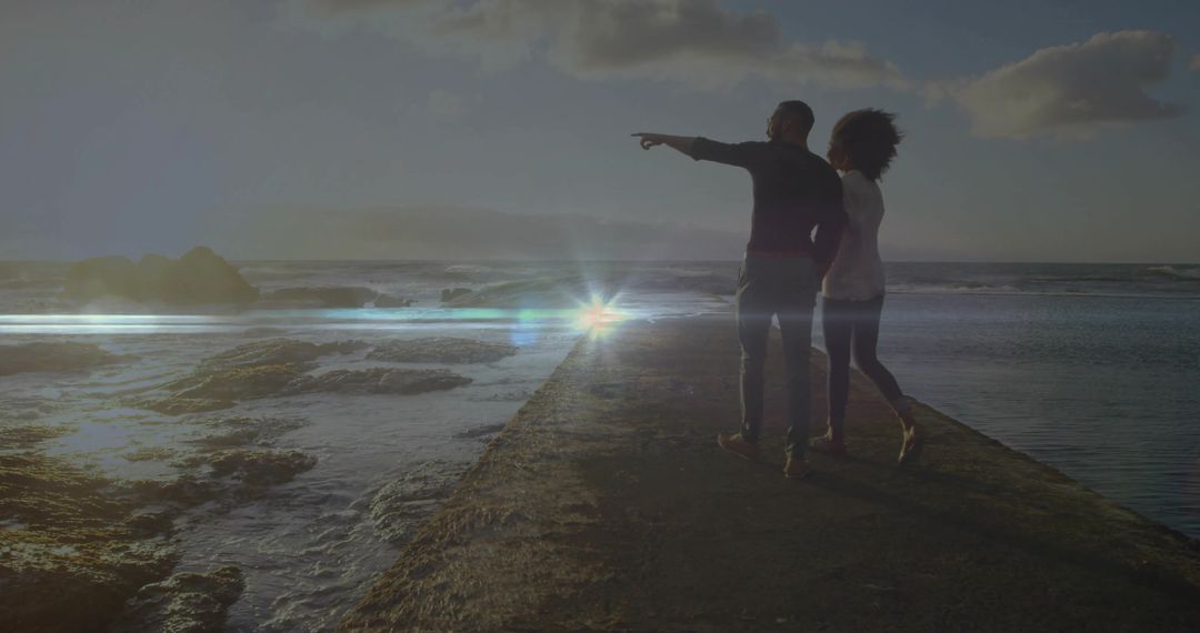 Couple on Oceanside Pier Enjoying Sunset Tranquility