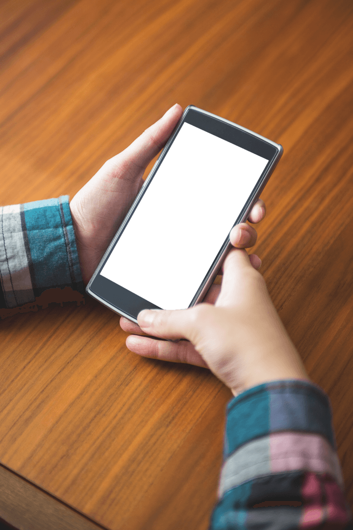 Transparent Smartphone in Hands with Wooden Table Background