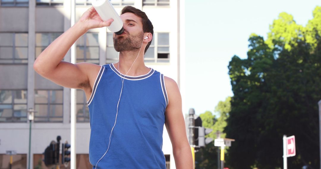 Young Man Hydrating While Exercising Outdoors on Sunny Day - Free Images, Stock Photos and Pictures on Pikwizard.com