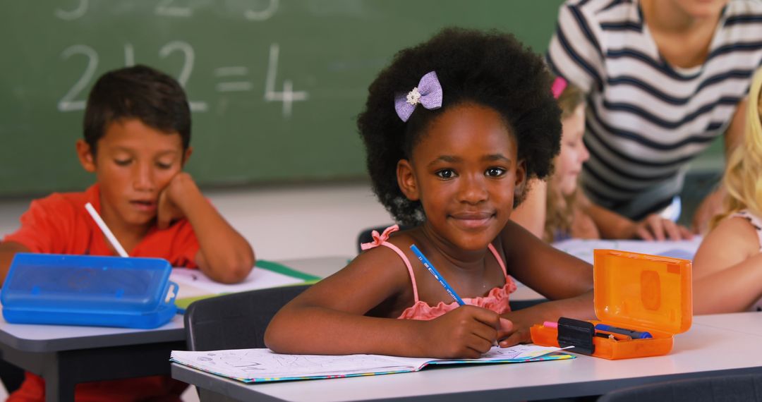 Smiling Young Girl in Classroom with Other Students - Free Images, Stock Photos and Pictures on Pikwizard.com