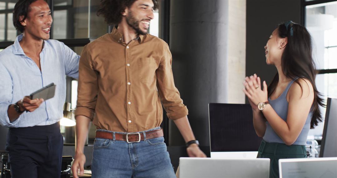 Diverse Team Collaborating Joyfully in Modern Office Environment