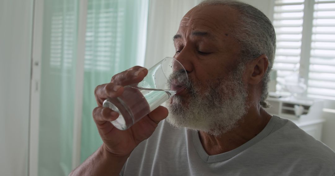 Elderly Man Drinking Water for Hydration at Home - Free Images, Stock Photos and Pictures on Pikwizard.com