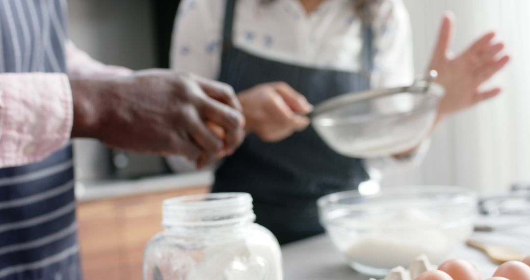 Diverse couple baking together in modern kitchen - Free Images, Stock Photos and Pictures on Pikwizard.com