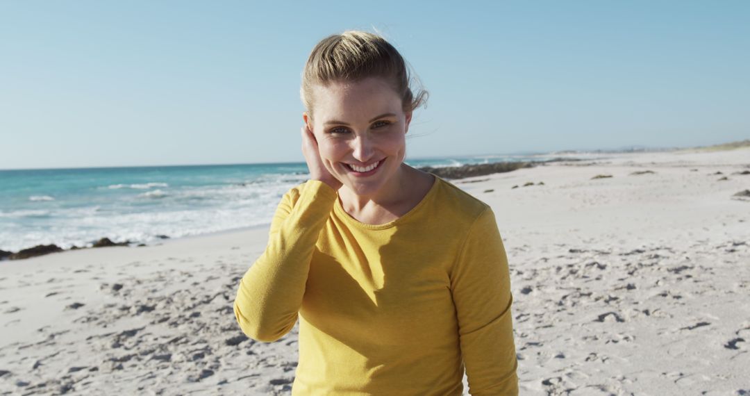 Happy Woman in Yellow Top Enjoying Beach Day by the Ocean - Free Images, Stock Photos and Pictures on Pikwizard.com