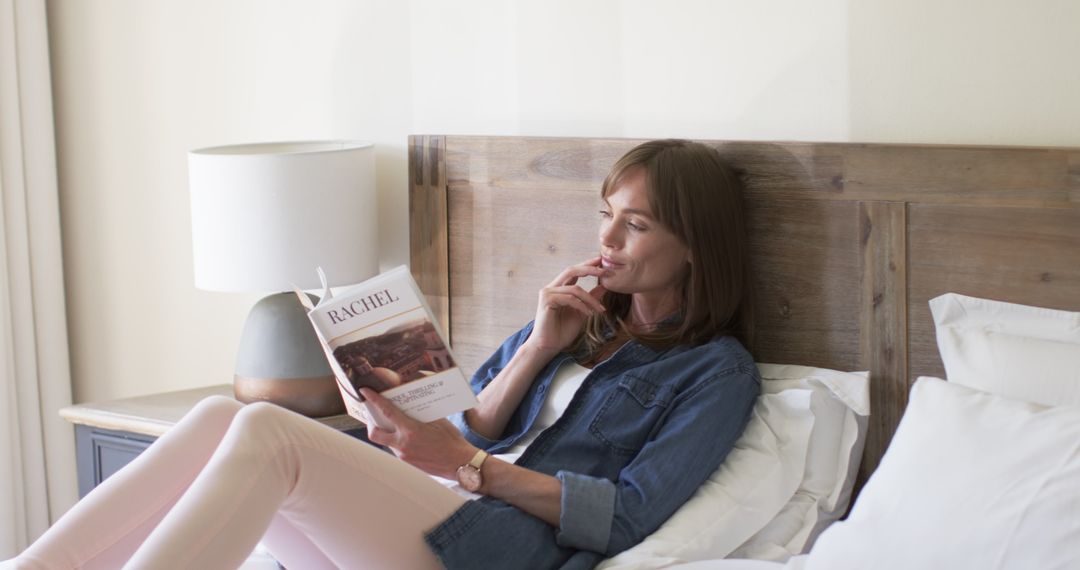 Woman Relaxing in Bed While Reading on a Calm Afternoon