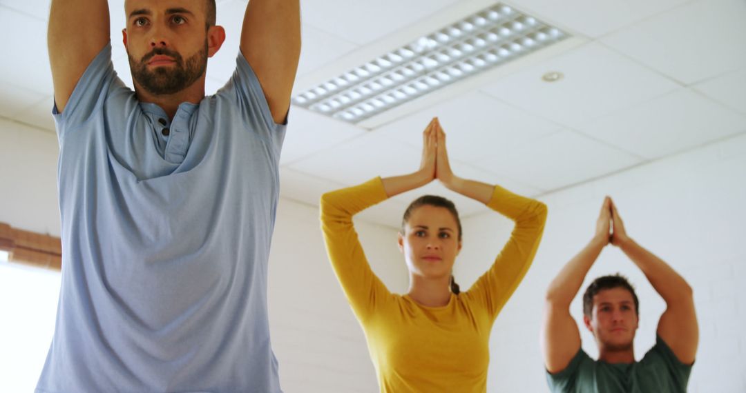 Group of Adults Practicing Yoga in Bright Room - Free Images, Stock Photos and Pictures on Pikwizard.com