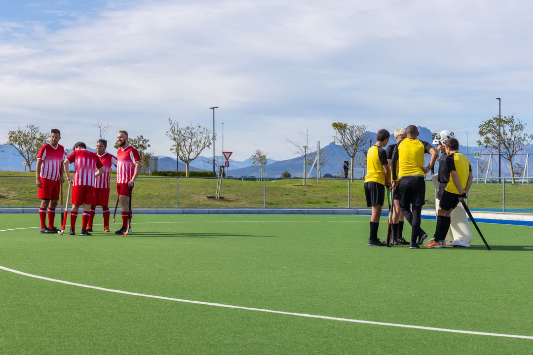 Field Hockey Players Huddle on Artificial Turf Daytime Match