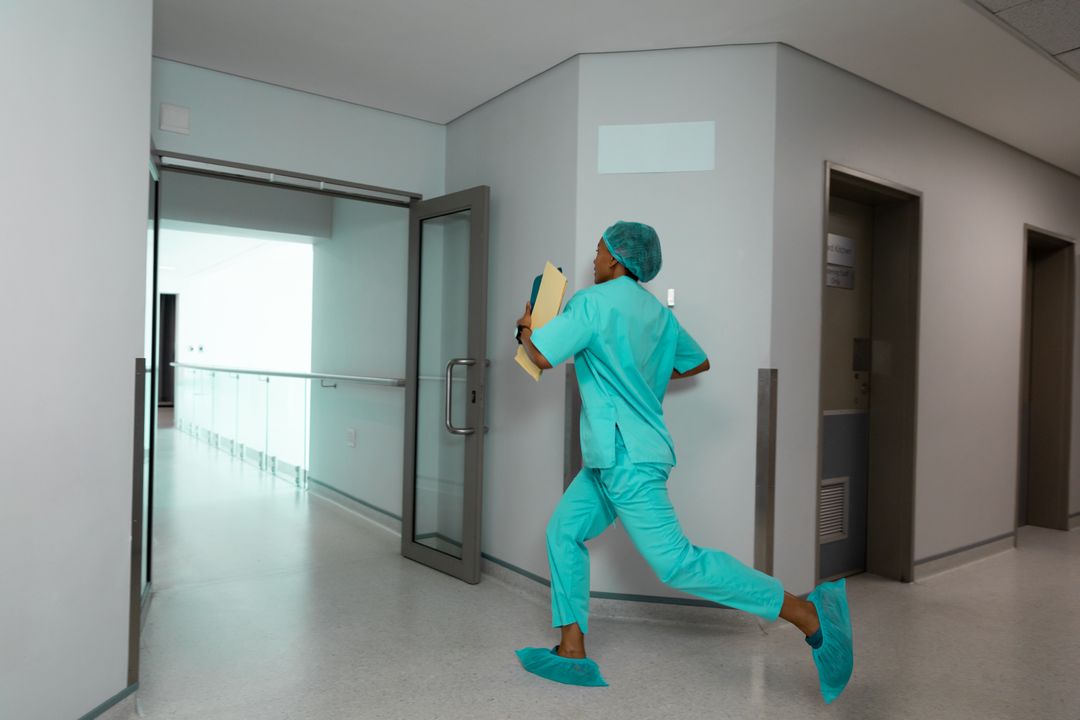 African American Female Doctor Running in Hospital Corridor - Free Images, Stock Photos and Pictures on Pikwizard.com