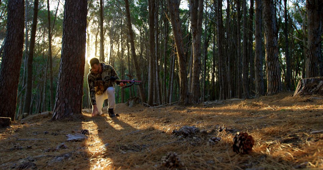 Man Bowhunting in Dense Pine Forest at Sunrise - Free Images, Stock Photos and Pictures on Pikwizard.com