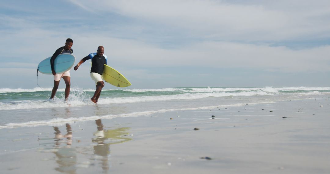 Two Friends Enjoying Surfing at Beach on Sunny Day - Free Images, Stock Photos and Pictures on Pikwizard.com