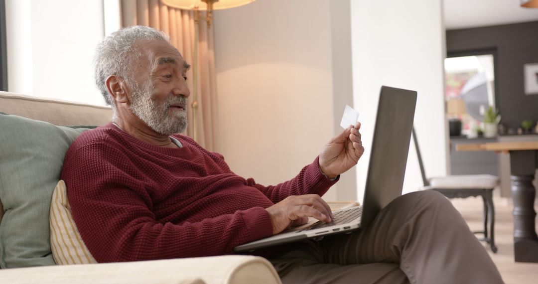 Senior man shopping online with laptop and credit card indoors - Free Images, Stock Photos and Pictures on Pikwizard.com