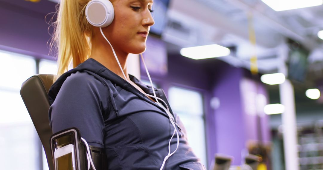 Woman Listening to Music While Exercising in Modern Gym - Free Images, Stock Photos and Pictures on Pikwizard.com