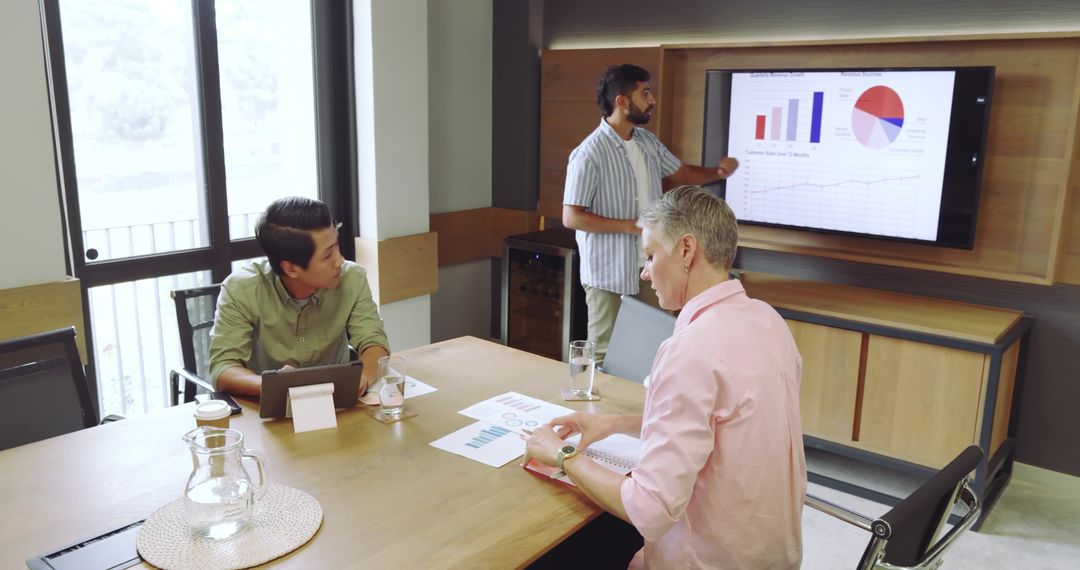 Diverse Team in Meeting Room Collaborating on Financial Analytics