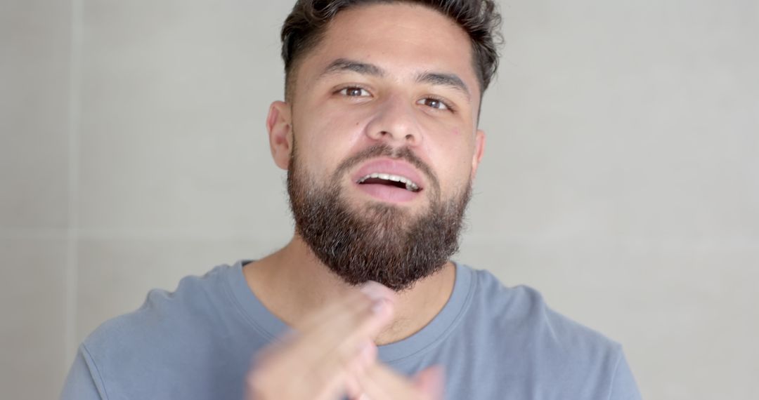 Bearded Man Speaking and Gesturing in Modern Bathroom