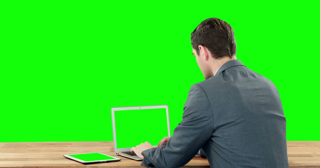 Businessman Working on Laptop with Green Screen Display in Office - Free Images, Stock Photos and Pictures on Pikwizard.com