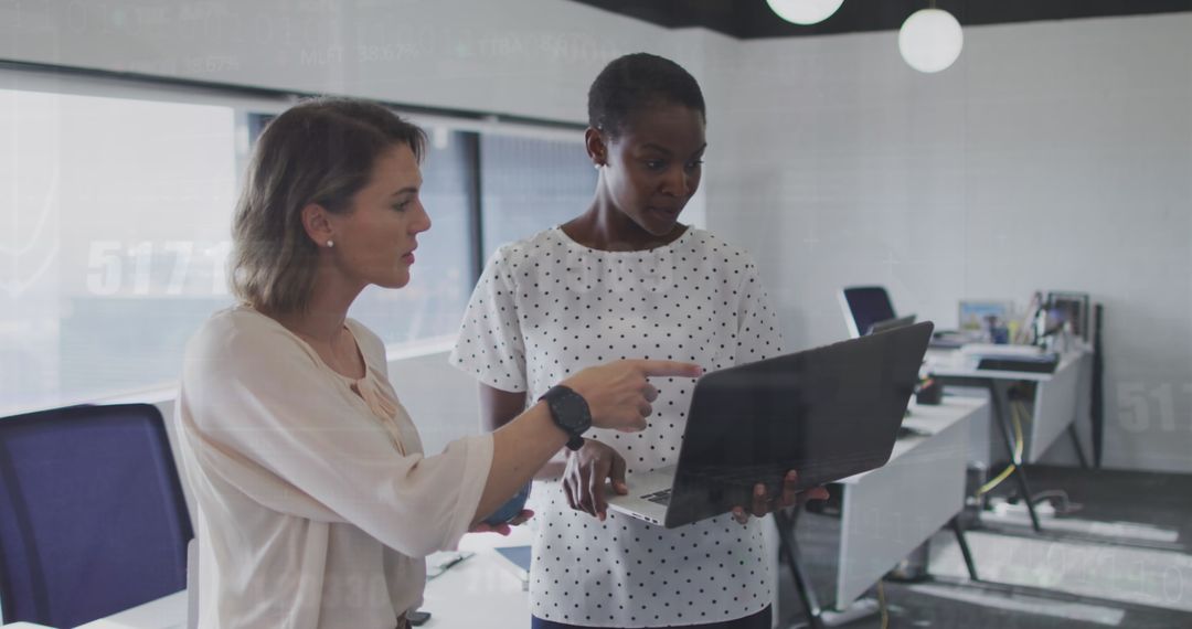 Diverse Business Team Analyzing Digital Financial Data on Laptop