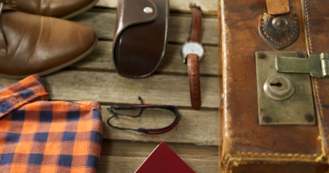 Men's travel essentials evoke a masculine adventure vibe on a wooden backdrop. - Free Images, Stock Photos and Pictures on Pikwizard.com