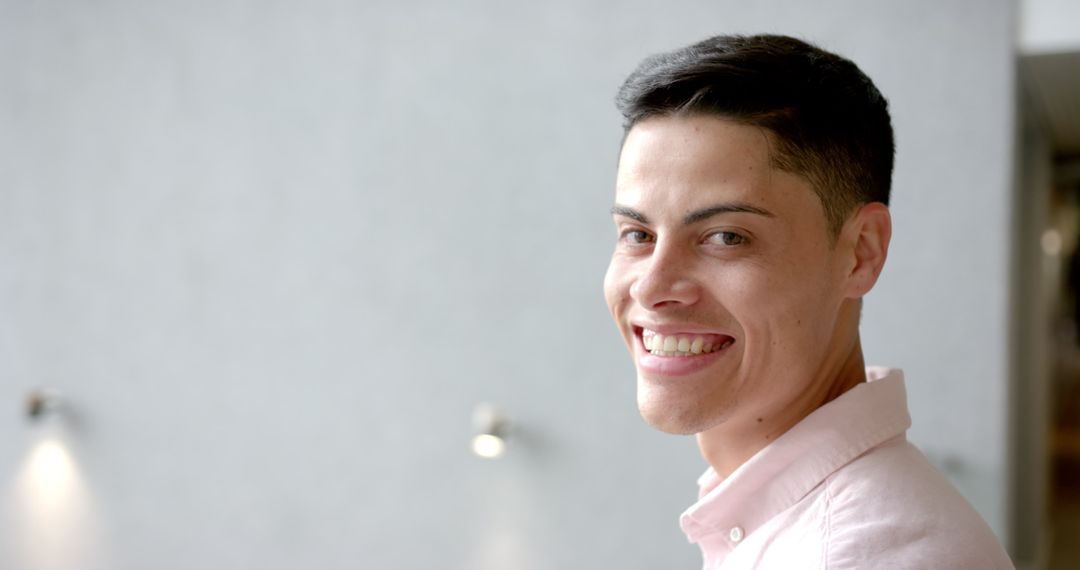 Joyful Man in Casual Pink Shirt Smiling with Confidence