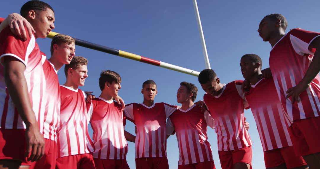 Multiethnic Soccer Team Huddling on Field under Blue Sky - Free Images, Stock Photos and Pictures on Pikwizard.com