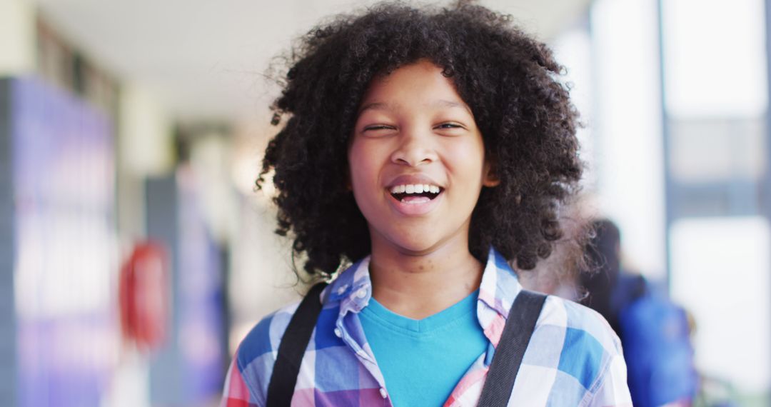 Happy Schoolboy with Backpack Smiling in Corridor - Free Images, Stock Photos and Pictures on Pikwizard.com