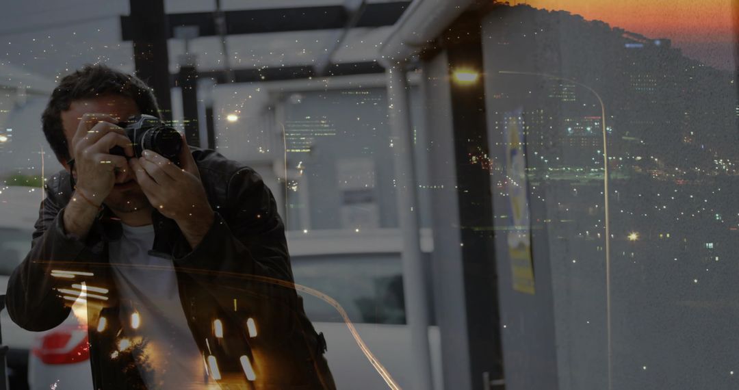 Photographer with DSLR Capturing Night Skyline Reflections