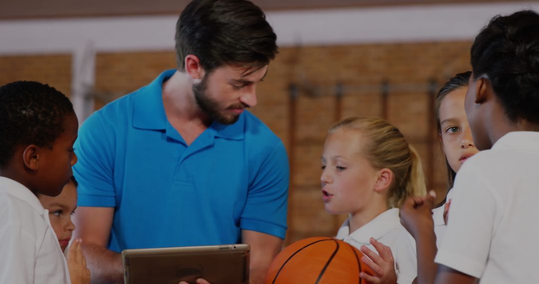 Coach Using Tablet for Kids' Basketball Training Session
