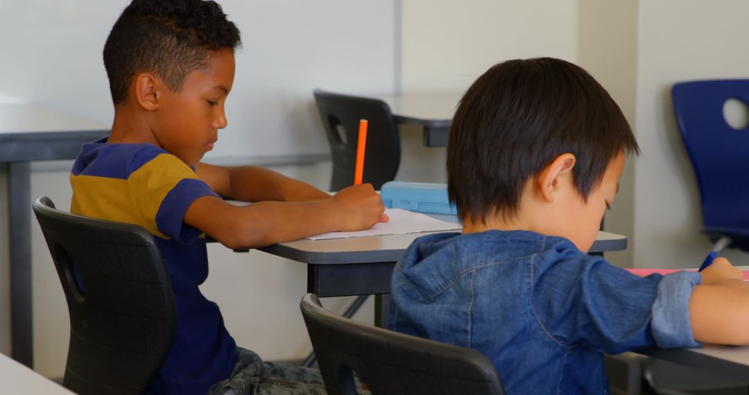 Focused Schoolchildren Studying at Classroom Desks