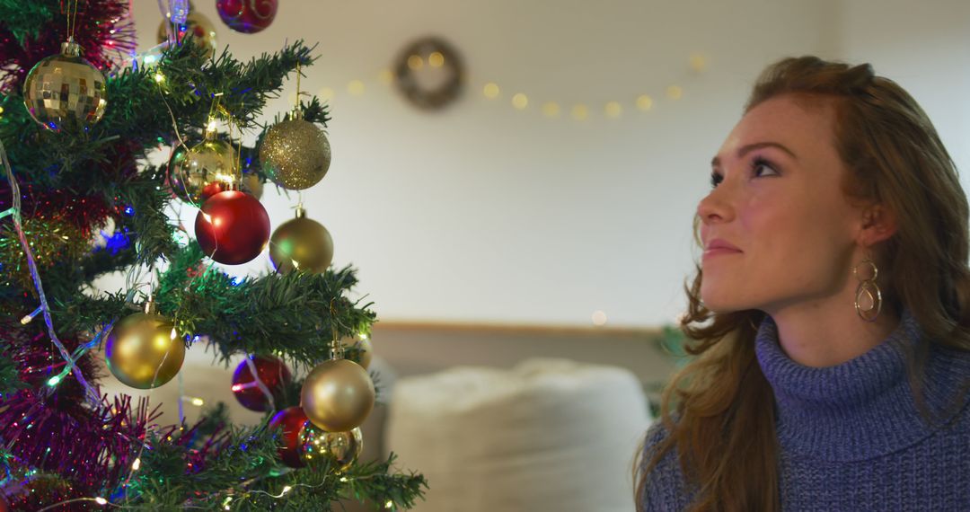 Woman Admiring Christmas Tree Decorations in Cozy Home - Free Images, Stock Photos and Pictures on Pikwizard.com