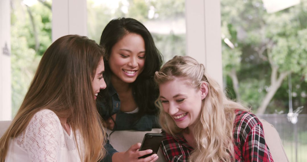 Diverse Group of Young Women Smiling at Smartphone - Free Images, Stock Photos and Pictures on Pikwizard.com