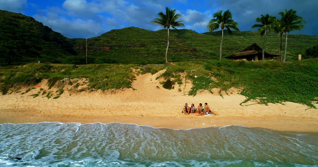 Diverse Group Relaxing on Tranquil Beach with Lush Hills - Free Images, Stock Photos and Pictures on Pikwizard.com