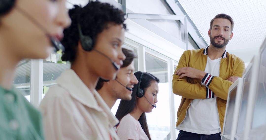 Customer Service Team Working in Call Center with Supervisor Overlooking - Free Images, Stock Photos and Pictures on Pikwizard.com