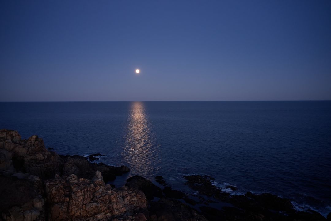 Full Moon Reflections Over Calm Ocean at Night