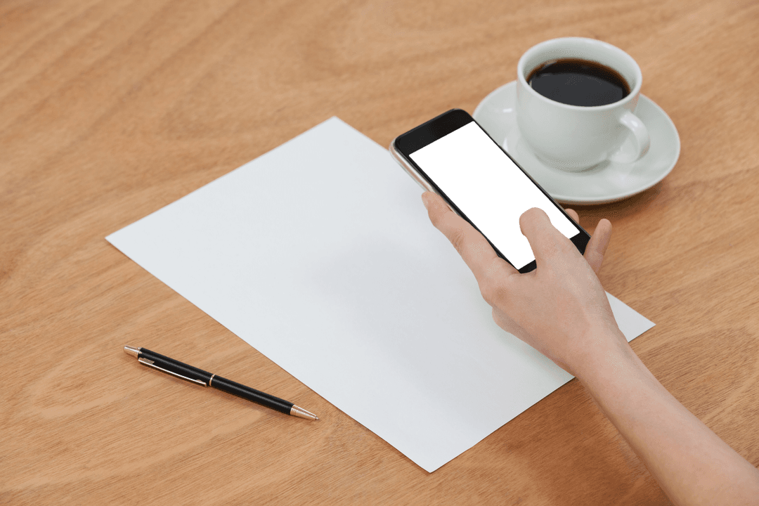 Transparent Screen Smartphone Next to Coffee Mug on Wooden Table