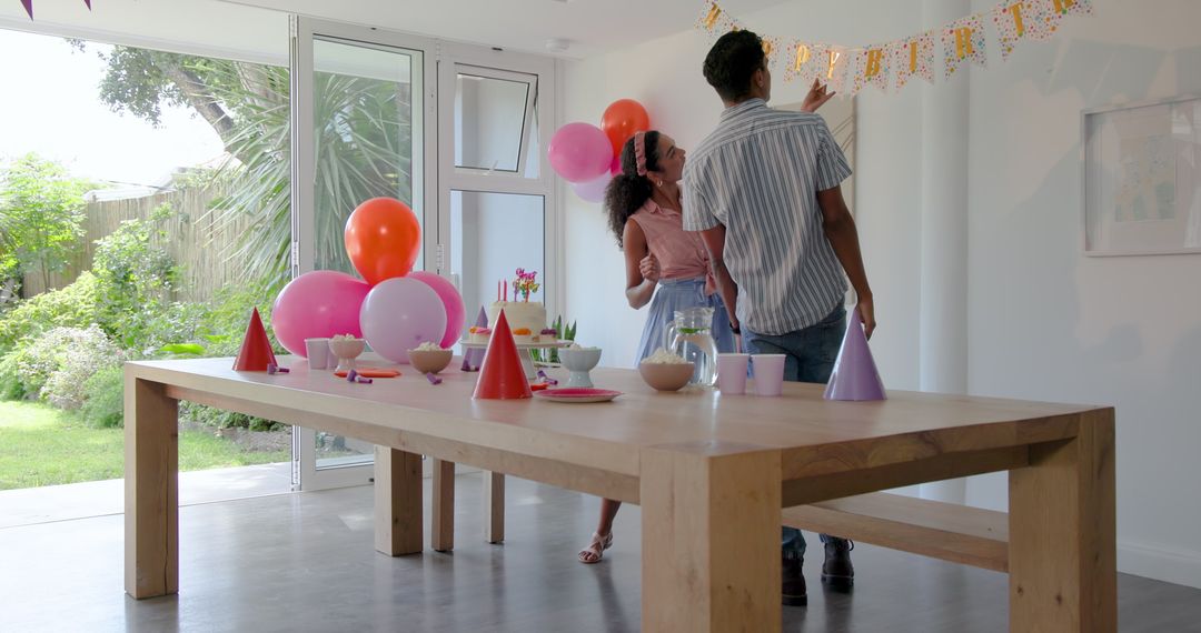 Couple Preparing for Celebration with Balloons and Tableware