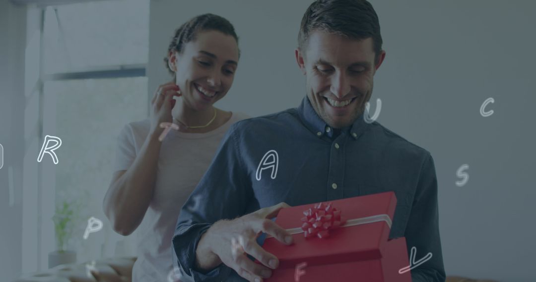 Man Opens Gift Box at Home with Joyful Friend