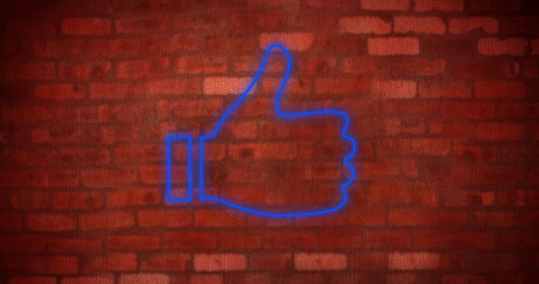 Glowing Neon Thumbs Up Icon on Red Brick Wall