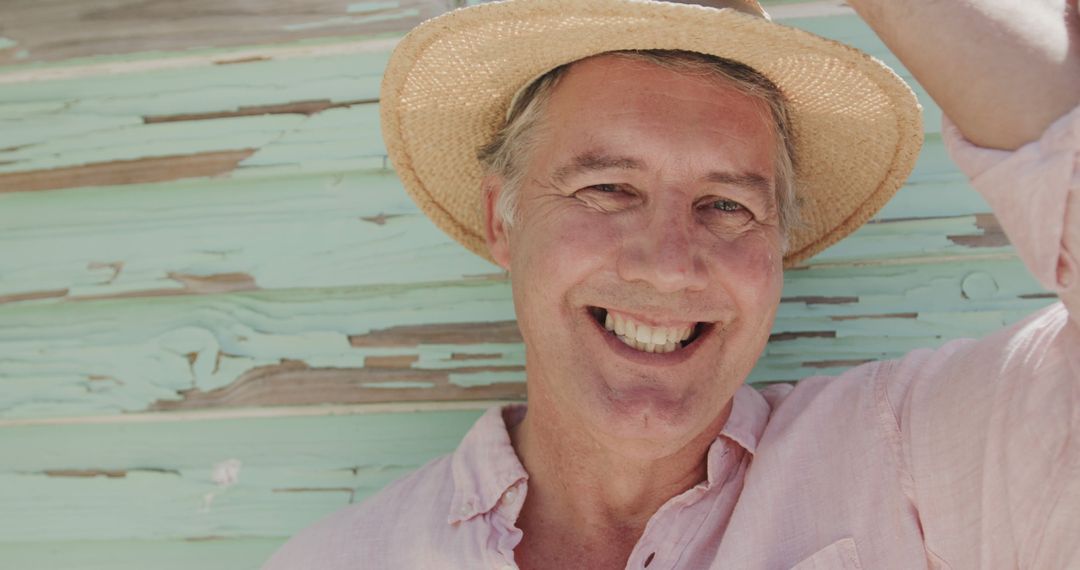 Happy Mature Man Wearing Straw Hat Smiling Outdoors - Free Images, Stock Photos and Pictures on Pikwizard.com