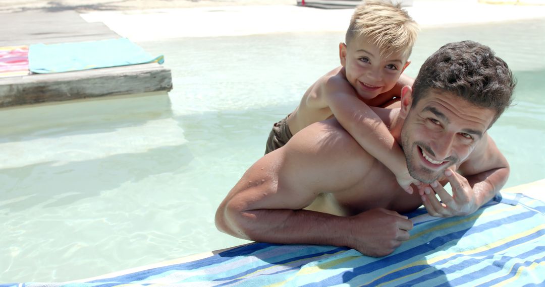 Happy Father and Son Enjoying Poolside Vacation Fun - Free Images, Stock Photos and Pictures on Pikwizard.com