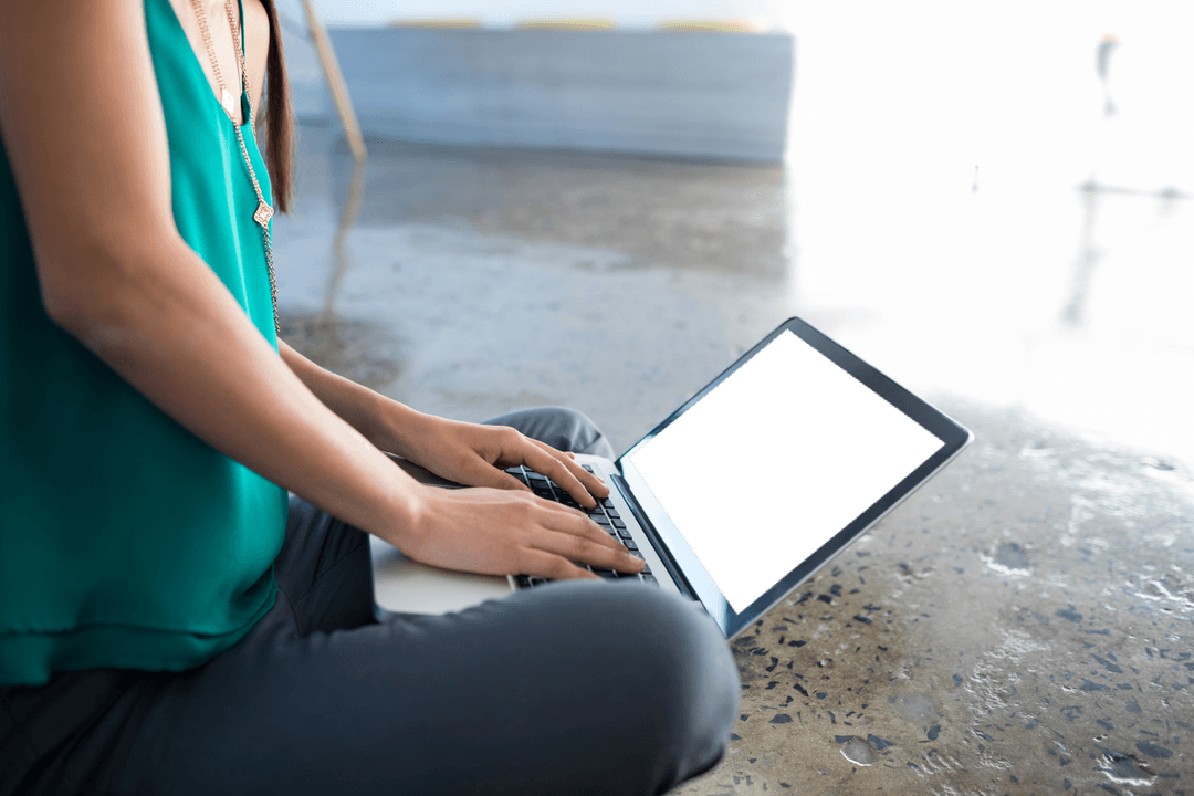Businesswoman Typing on Laptop with Transparent Screen Indoors
