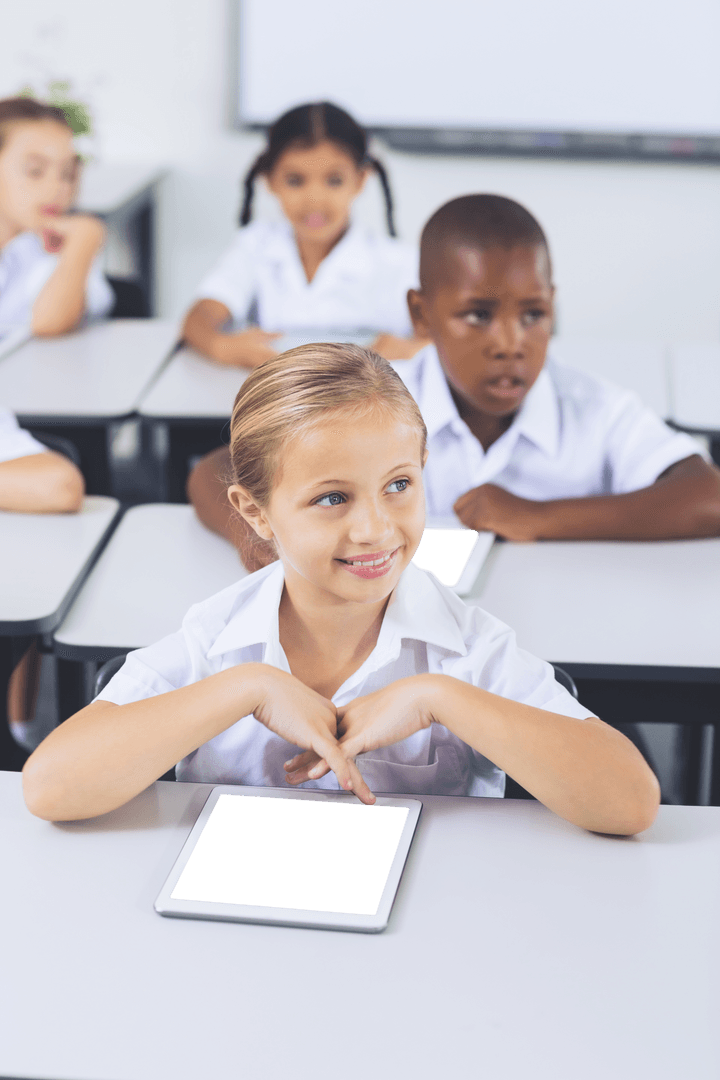 Smiling Schoolgirl Using Transparent Digital Tablet in Classroom Setting
