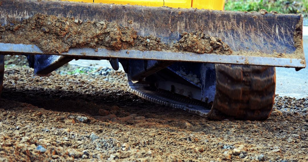 Close-up of Bulldozer with Tracks Moving Dirt at Construction Site - Free Images, Stock Photos and Pictures on Pikwizard.com