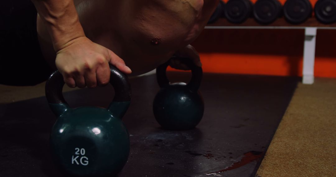 Man performing kettlebell push-ups in gym - Free Images, Stock Photos and Pictures on Pikwizard.com